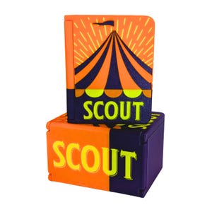 May include: A rectangular orange and purple plastic case featuring a circus tent graphic and the word SCOUT printed in lime green. The case is shown in two positions, one standing vertically and one lying horizontally, both displaying the text.