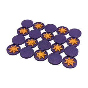Puede incluir: Una colecci&oacute;n de fichas de juego moradas y naranjas. Las piezas moradas son redondas con una superficie texturizada. Algunas piezas presentan un dise&ntilde;o de sol naranja en relieve. Las piezas est&aacute;n dispuestas sobre un fondo blanco.