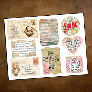 May include: A collection of decorative stickers with inspirational quotes and floral designs. The stickers include phrases like "Be kind," "Trust in the Lord," and "Never Stop Dreaming." The color palette includes soft pastels and vintage-style elements.