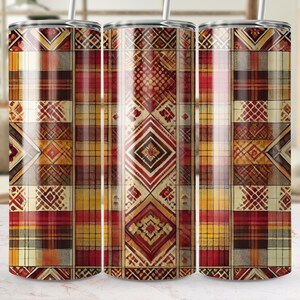 May include: Three stainless steel tumblers with a colorful geometric pattern. The pattern features a mix of red, orange, yellow, and brown colors. The tumblers are perfect for keeping drinks cold or hot.