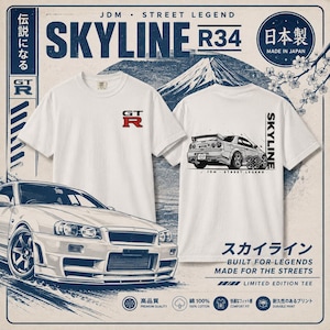 May include: A white t-shirt featuring a small red and black GT-R logo on the front chest. The back displays a detailed illustration of a Skyline R34 car, the text SKYLINE, and the words JDM STREET LEGEND. The design includes Japanese characters.