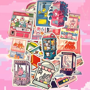 May include: A collection of colorful stickers featuring claw machine designs. The stickers showcase various claw machine illustrations with cute animal characters, rainbows, and Japanese text. The color palette includes pink, blue, and yellow.