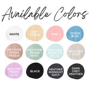 May include: Image displaying a color chart with the text "Available Colors" in a handwritten font. The chart features twelve color swatches labeled: White, Soft Cream, Pink, Ocean Blue, Heather Prism Peach, Heather Prism Mint, Heather Prism Ice Blue, Heather Dust, Heather Prism Lilac, Black, Heather Midnight Navy, and Dark Grey Heather.