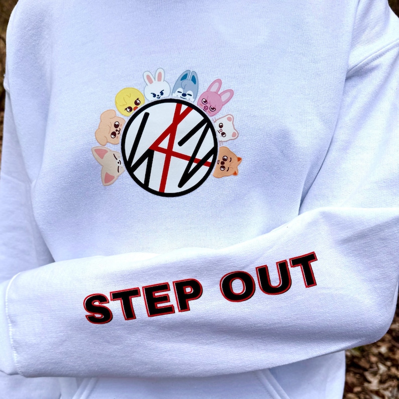 May include: White hoodie featuring a graphic of cartoon animal faces around a black and red design. The sleeve displays the words "STEP OUT" in red letters with a black outline.