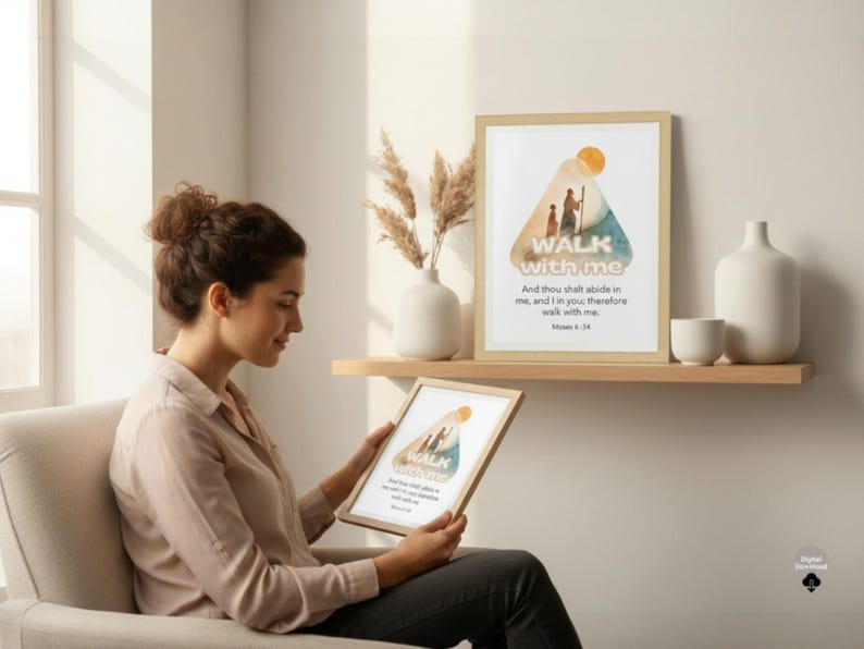 May include: A framed print with the words "WALK with me" and a watercolor illustration of two figures walking. The print is displayed on a shelf with other decorative items. The image also shows a woman holding a similar framed print.