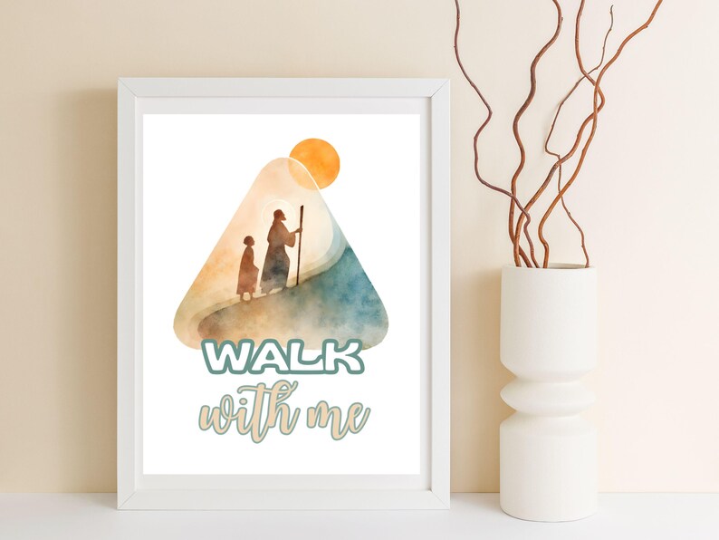 May include: White framed art print featuring a watercolor illustration of two figures walking up a hill towards a sun. The words "WALK with me" are written in a teal and cursive font. A white vase with brown branches is to the right.