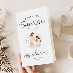 May include: A white baptism invitation card with the words "Welcome to the Baptism" in elegant script. The card features an illustration of a baptism scene with a dove and the name "Lily Anderson" and the date and time.