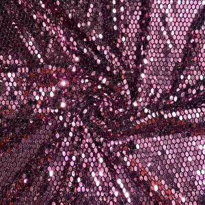 May include: Pink iridescent fabric with a hexagonal sequin pattern.