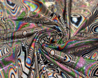 May include: A close-up of iridescent fabric with a swirling, abstract pattern in black, white, and rainbow colors. The fabric has a glittery texture.
