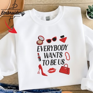 May include: A set of three ceramic mugs with a speckled, matte finish. The mugs are in shades of cream, light gray, and dark gray. Each mug has a simple, minimalist design, perfect for coffee or tea.