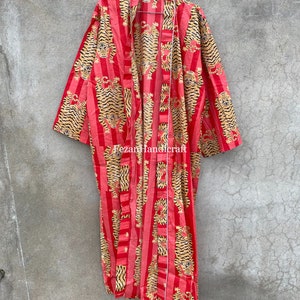 May include: A red and gold striped kimono with a tiger print. The kimono has a long, flowing silhouette and is perfect for layering over other clothing.