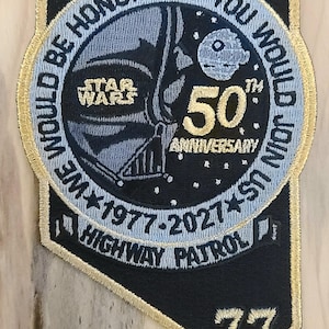 May include: Embroidered patch featuring Darth Vader from Star Wars, celebrating the 50th anniversary. The patch includes the text "Would be honoured if you would join us" and "Highway Patrol". The patch is black, blue, and gold.