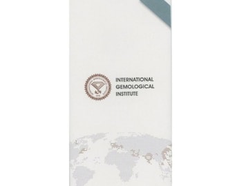 May include: A white brochure with a world map graphic and the text "INTERNATIONAL GEMOLOGICAL INSTITUTE". The brochure also features a circular seal with the text "IGI" and "1975". The bottom of the brochure reads "THE GLOBAL AUTHORITY IN DIAMOND, GEMSTONE AND JEWELRY GRADING".