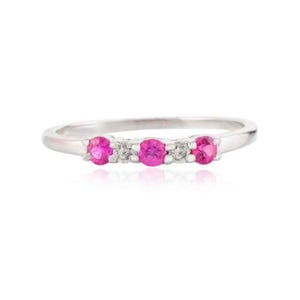 May include: A delicate silver band ring with three pink gemstones and smaller white gemstones set in a curved row.