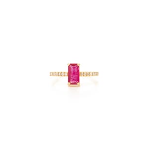 May include: A gold ring with a striking rectangular pink gemstone at its centre. The band is embellished with tiny diamonds, providing a subtle contrast to the vivid central stone. This piece of jewellery is a statement of elegance and sophistication.