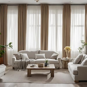 May include: A living room with a light brown sofa, two matching armchairs, a wooden coffee table, and a rug. The room has large windows with sheer curtains and brown drapes.