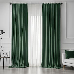 May include: A pair of dark green velvet curtains with a white sheer curtain behind them. The curtains are hung on a black curtain rod.