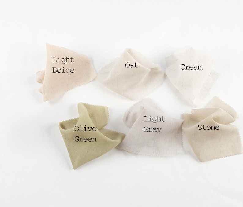 May include: Six fabric swatches with frayed edges arranged in a group. The colors are labeled as Light Beige, Oat, Cream, Olive Green, Light Gray, and Stone. Each piece of fabric has a soft, textured appearance and is displayed against a plain white background.
