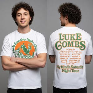 May include: White t-shirt featuring a green and orange graphic with a deer and the text "My Kinda Saturday Night Tour" and "Luke Combs." The back of the shirt displays "Luke Combs" and tour locations in green and orange.