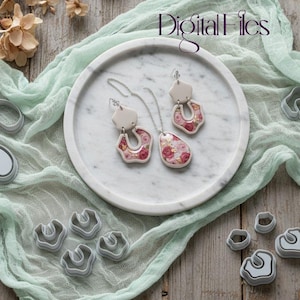 May include: A marble tray displays a necklace and earrings with a floral design. The jewelry features a cream-colored base with pink and gold accents. Gray polymer clay cutters surround the tray, along with the text "Digital Files".