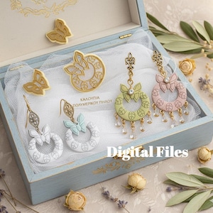 May include: A light blue wooden box with gold detailing displays several earrings and butterfly decorations. The earrings have bow and crystal pendant designs. The text "Digital Files" is visible.