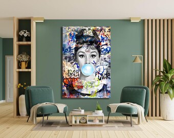 May include: A rectangular wall art print featuring a black and white portrait of a person with an updo hairstyle, wearing a beaded necklace, and blowing a large, bright blue bubble. The background is a collage of colorful graffiti and text.