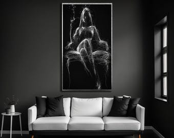 May include: A rectangular wall art piece featuring a white scribble-style line drawing of a person sitting on a chair against a solid black background. The artwork is framed in a thin metallic border and displayed on a dark grey wall.