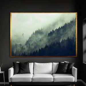May include: A rectangular wall art piece featuring a landscape of dark pine trees shrouded in thick, heavy fog. A small, light-colored flying craft is visible in the distance. The artwork is enclosed in a thin, textured gold-colored frame.