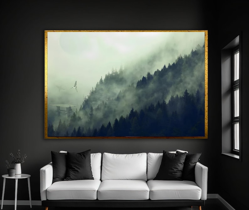May include: A rectangular wall art piece featuring a landscape of dark pine trees shrouded in thick, heavy fog. A small, light-colored flying craft is visible in the distance. The artwork is enclosed in a thin, textured gold-colored frame.