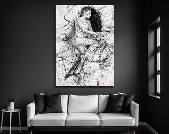 May include: A rectangular wall art print featuring a black and white photograph of a person lying down, covered in dark paint splatters. The high-contrast image displays a dynamic pattern of drips and splashes across the entire surface.