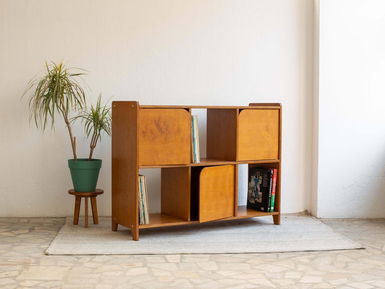 Mid-century modern sideboard made from eco-plywood, featuring hinged doors and open shelves to showcase decorative objects.