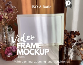 May include: A white rectangular video frame mockup with the text "Video FRAME MOCKUP" and "PSD File". The image includes dried flowers in vases and a basket of pink roses, set against a wooden and white background.