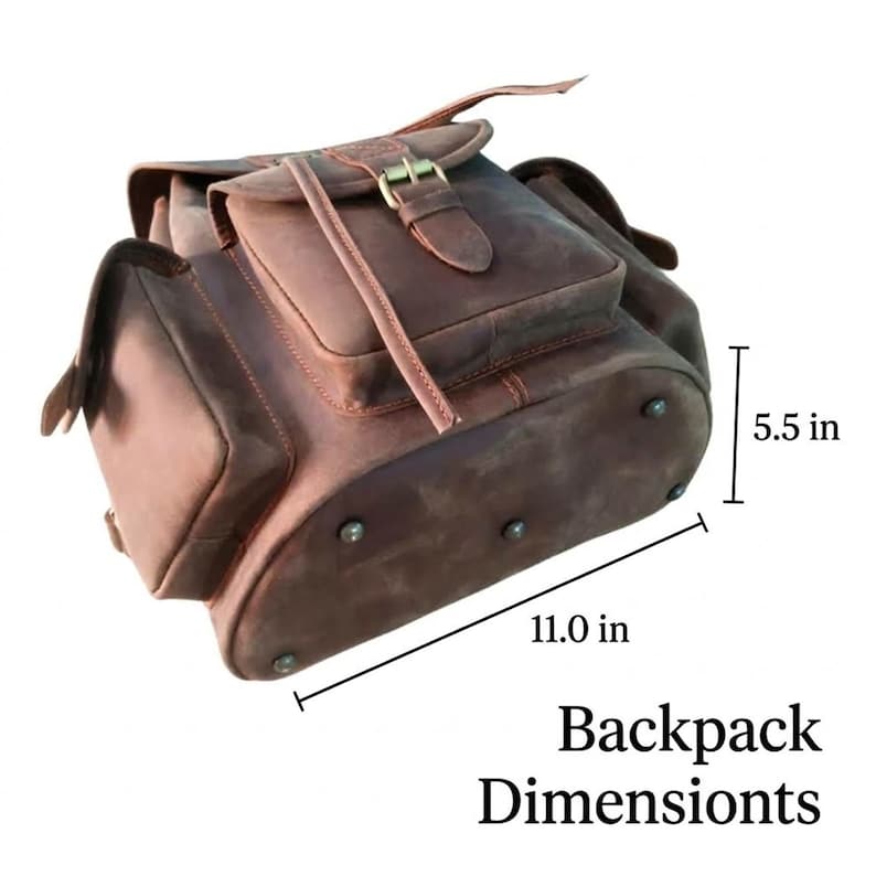 May include: A brown leather backpack featuring a front pocket with a buckle closure, side pockets, and metal feet on the base. The backpack measures 11.0 inches in width and 5.5 inches in depth, as indicated by the text and dimension lines.