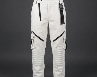 May include: Cream-coloured trousers with black detailing, including cargo pockets and quilted knee panels. The trousers have a black belt and zips. The design is modern and stylish.