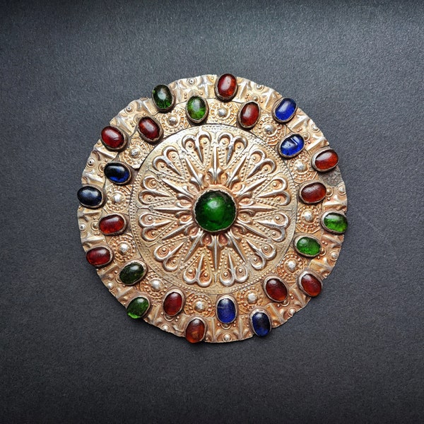 Ancient Turkoman ornamental breast button in gilded silver and glass of various colors.