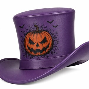 Puede incluir: Un sombrero de copa de color morado con un gr&aacute;fico impreso de una calabaza naranja con cara de linterna, rodeada de patrones de filigrana negros y peque&ntilde;as siluetas de murci&eacute;lagos. El sombrero tiene un acabado liso y un ala ancha y curva.