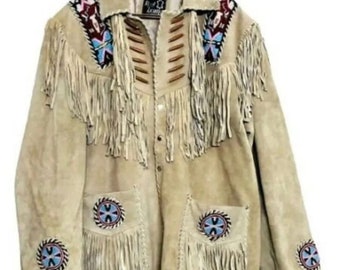 May include: A beige suede jacket with fringe detailing and beaded accents. The jacket has a button-up front and two pockets. The jacket is decorated with Native American inspired designs.