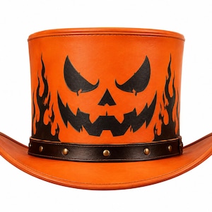 May include: An orange top hat featuring a black jack-o'-lantern face graphic on the front and black flame patterns on the sides. The hat includes a dark brown leather-like band around the base decorated with small metallic studs along the brim.