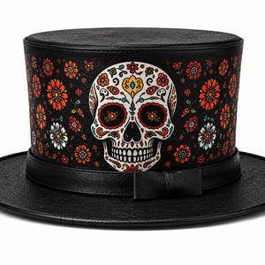 May include: A black top hat featuring a central white sugar skull graphic with intricate red, yellow, and blue floral patterns. The hat has a textured finish, a wide brim, and a black band with a small bow detail at the front base of the crown.