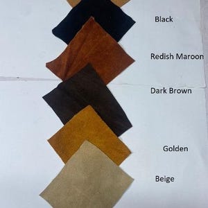 May include: A collection of fabric swatches in various colors, including tan brown, black, reddish maroon, dark brown, golden, and beige. The swatches are arranged in a vertical line, with color names labeled on the right.