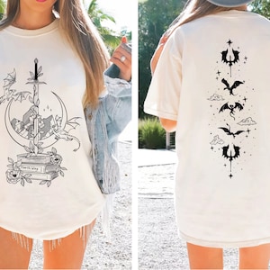 a woman wearing a white t - shirt with black ink on it