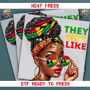 May include: DTF ready to press graphic featuring a Black woman with braided hair, wearing gold-rimmed sunglasses with a flag design. The image includes the text "THEY NOT LIKE US" and "HEAT PRESS".