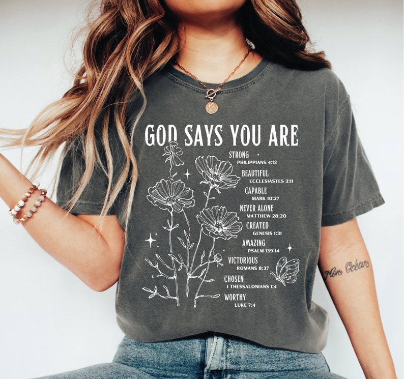a woman wearing a t - shirt that says god says you are