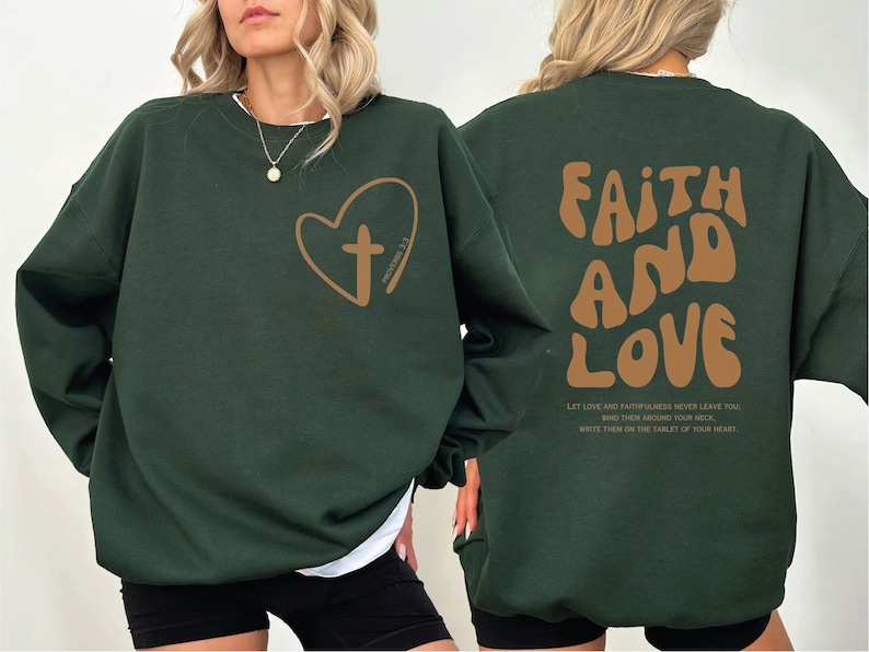 a woman wearing a green sweatshirt with a heart and a cross on it