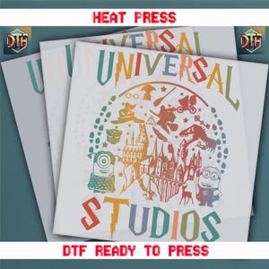 May include: A white t-shirt with a rainbow colored graphic of the Universal Studios logo. The graphic includes images of popular characters and attractions, including Harry Potter, Minions, and Jurassic Park. The text "HEAT PRESS" and "DTF READY TO PRESS" are also included in the graphic.