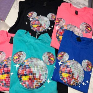 a group of t - shirts with mickey mouse designs on them