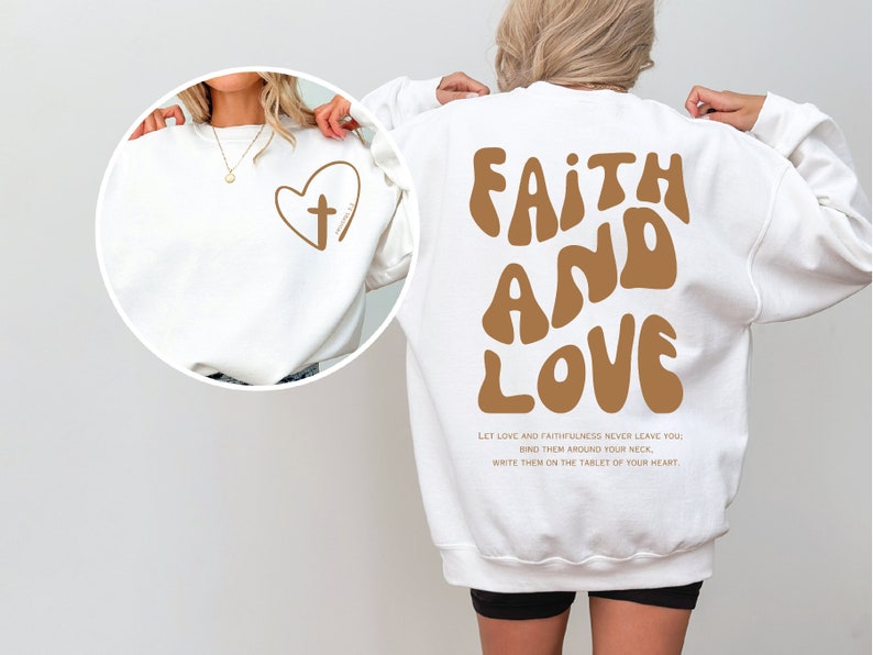 a woman wearing a sweatshirt with the words faith and love printed on it