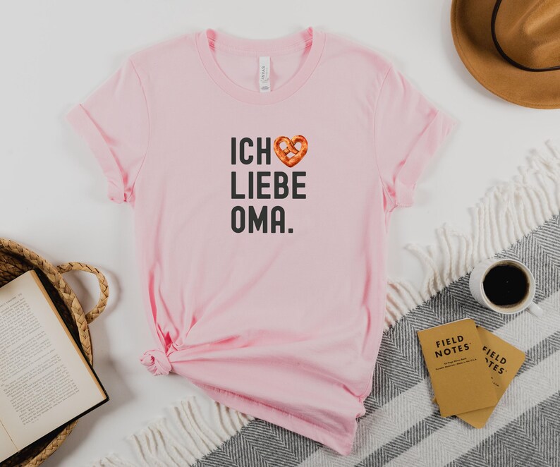 May include: Pink t-shirt with a pretzel heart and the text "ICH LIEBE OMA."