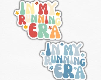 May include: Two die-cut stickers featuring the text "IN MY RUNNING ERA" in a wavy, bold font. The top sticker uses a multi-colored palette of red, teal, yellow, and orange with small orange flowers. The bottom sticker uses shades of blue with light blue flowers.