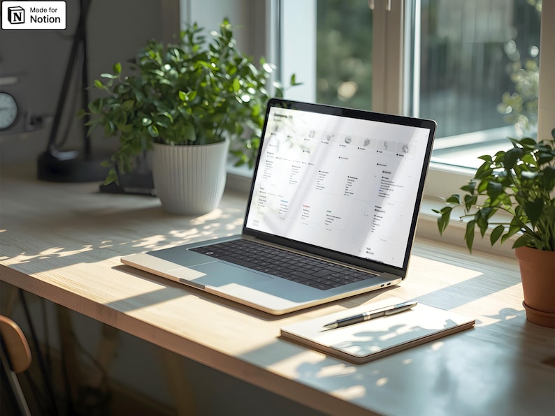 May include: A laptop displaying a webpage sits on a wooden desk, next to a notepad and pen. Potted plants are in the background. The laptop is open, showing a list of items. The scene is lit by natural light.